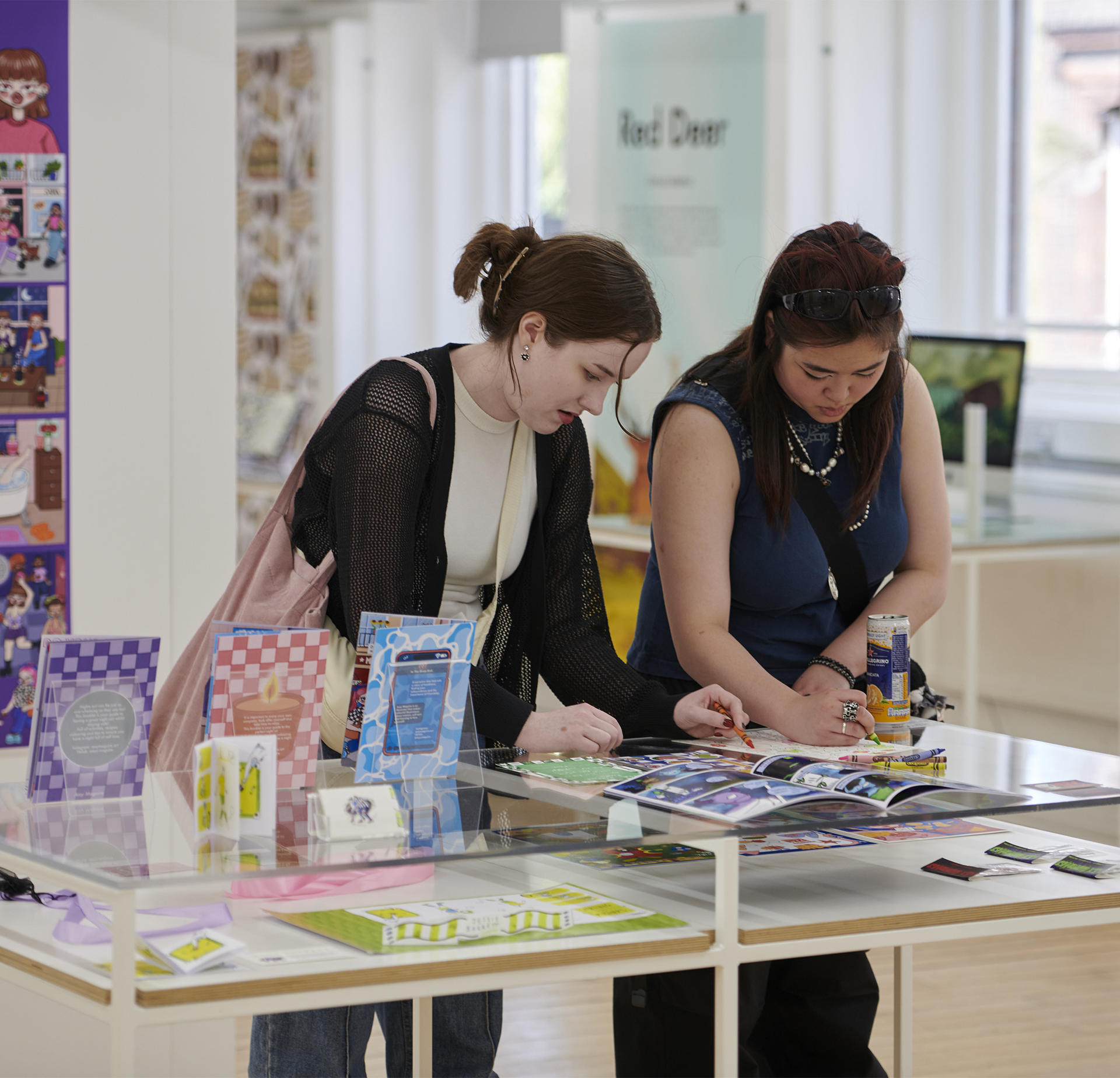 Visitors interacting with the Illustration work on display at GradFest.