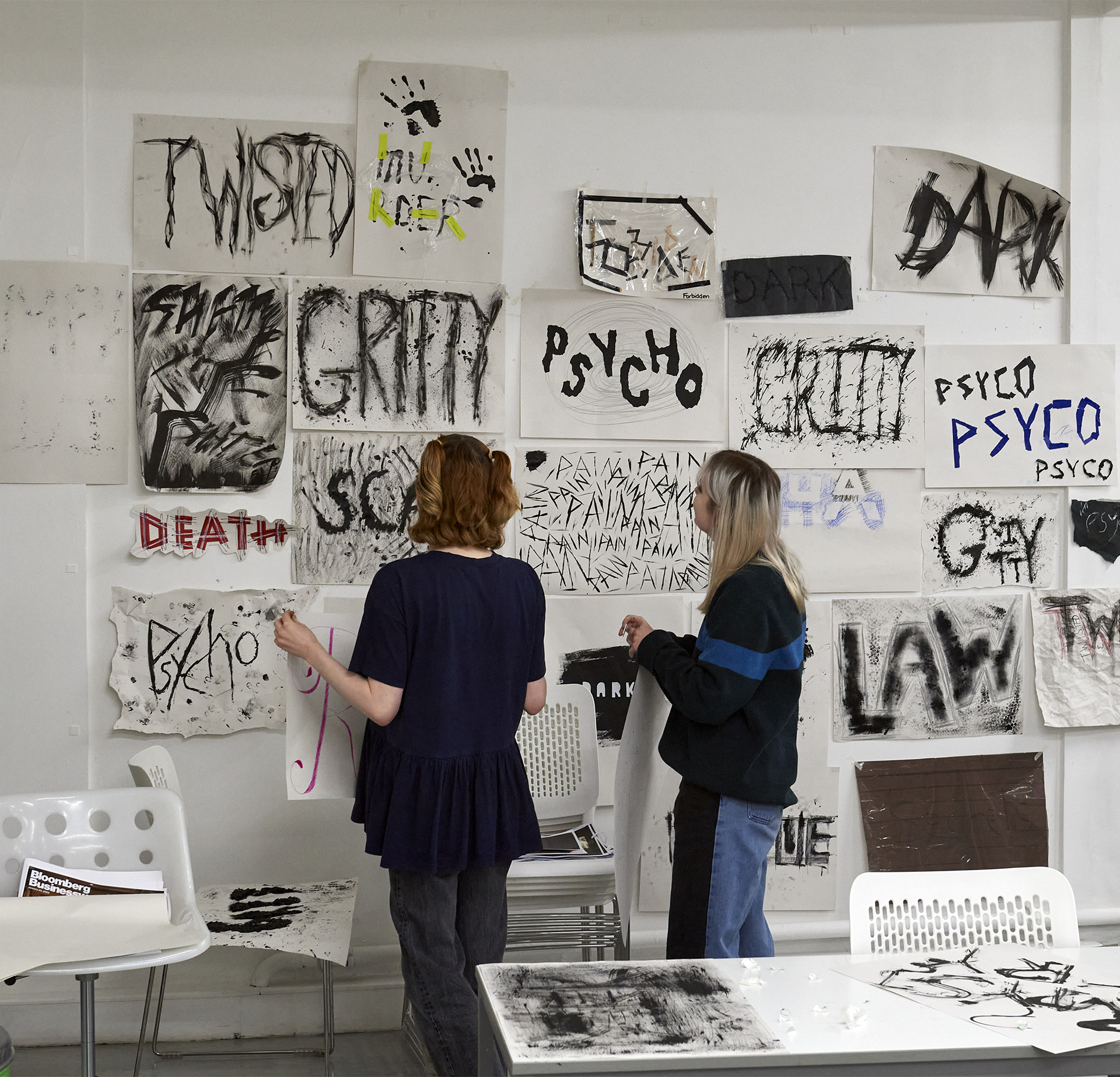 Graphic Comms students working on a wall of hand drawn typography.