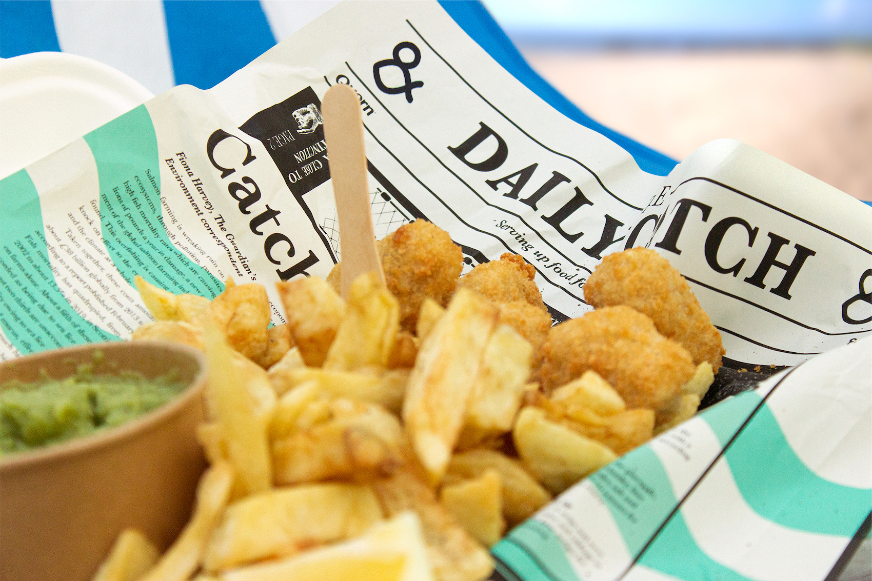 An image of plant-based Quorn Fishless Nuggets and chips served in a traditional-style branded newspaper.