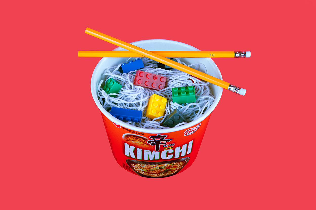 A mixture of string and lego to create the illusion of ramen, to be eaten with the pencil chopsticks.
