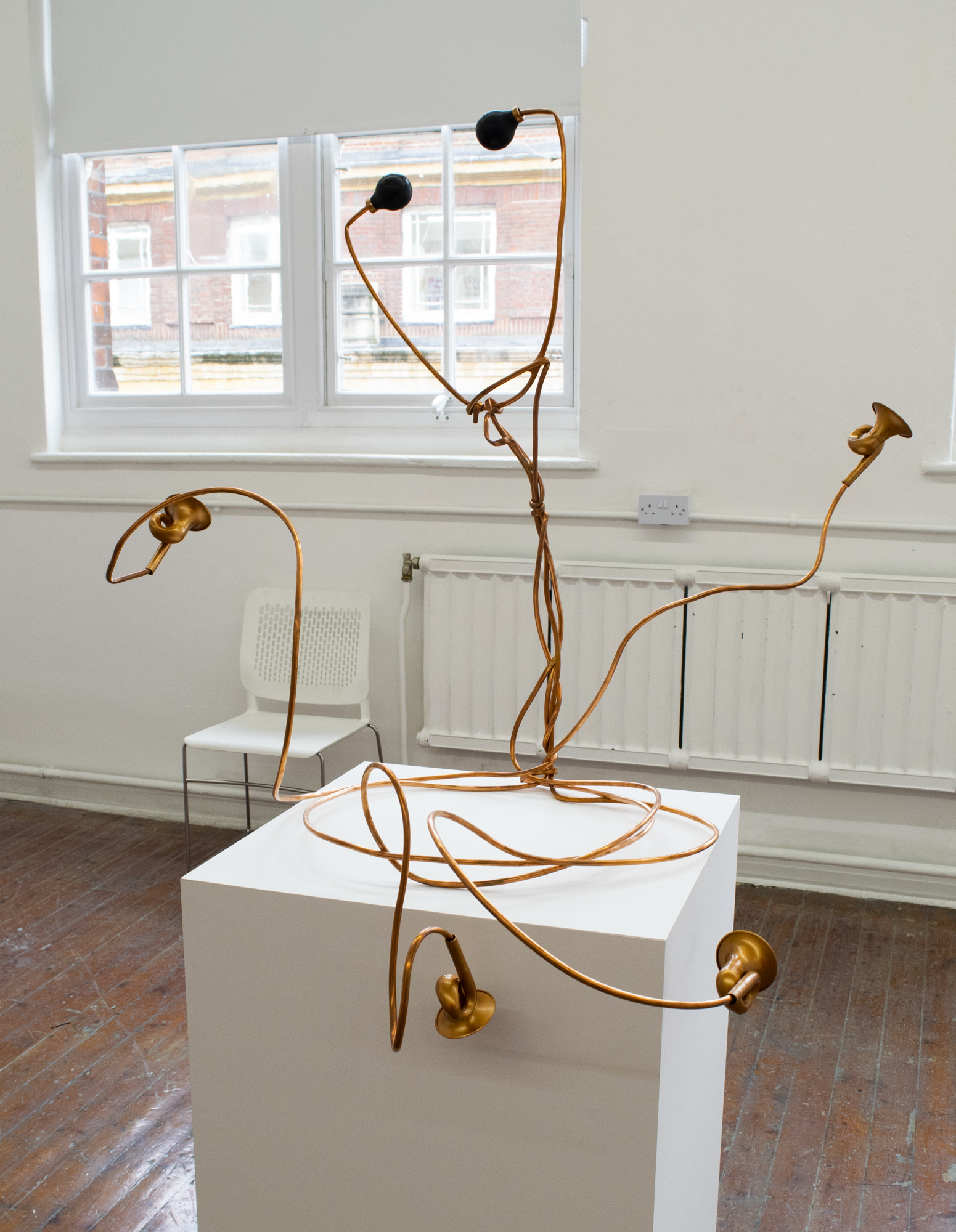 BA Fine Art work by Freya Parfitt showing a stethoscope-like sculpture made from copper microbore pipe and bicycle bells.