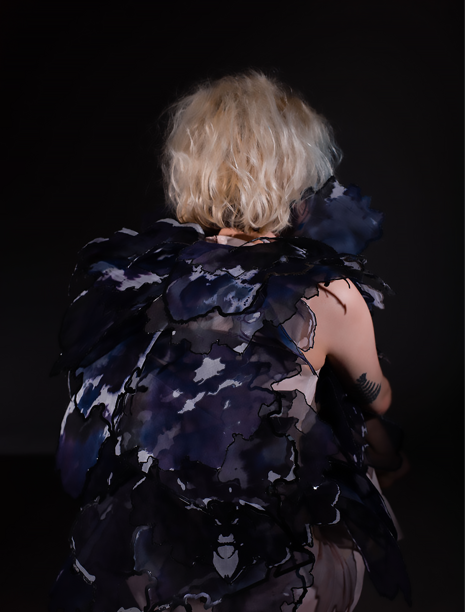 'BA Fashion Design work by Grace Bridges inspired by depression: showing the close up back of a skintight "skin fabric" dress adorned in 70+ dyed abstract panels that cover the top portion of the dress.'