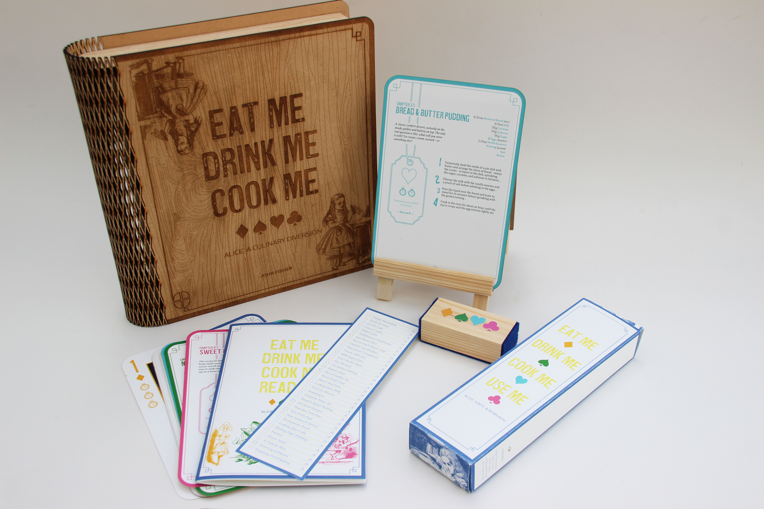 BA Design for Publishing work by Hannah Goldsmith showing an Alice in Wonderland inspired Cookbook Set. Including an engraved wooden box, Recipe Cards and a small chalkboard card stand.