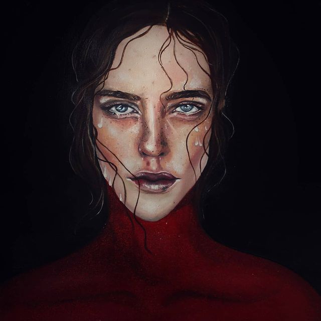 BA Fine Art work by Kamila Jakubiak showing a portrait of a woman with a strong gaze, she is surrounded by deep black and her neck and shoulders are covered in red glitter.