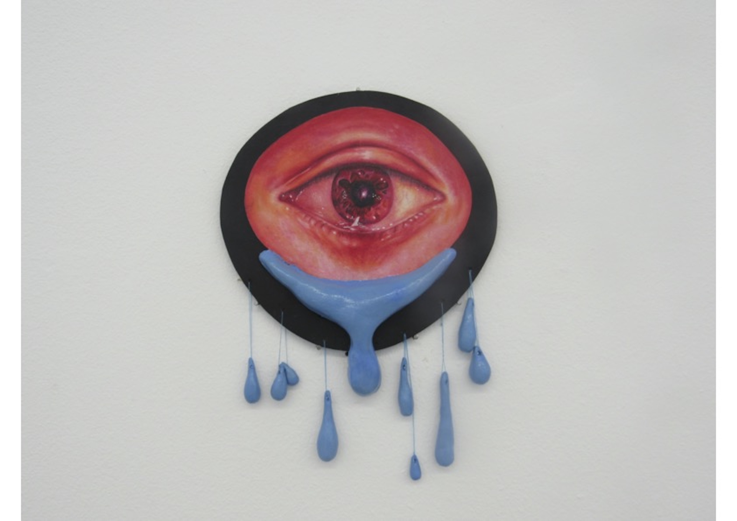 BA Fine Art work by Kate Chaplin showing a double-sided red coloured eye crying blue sculptural tears.