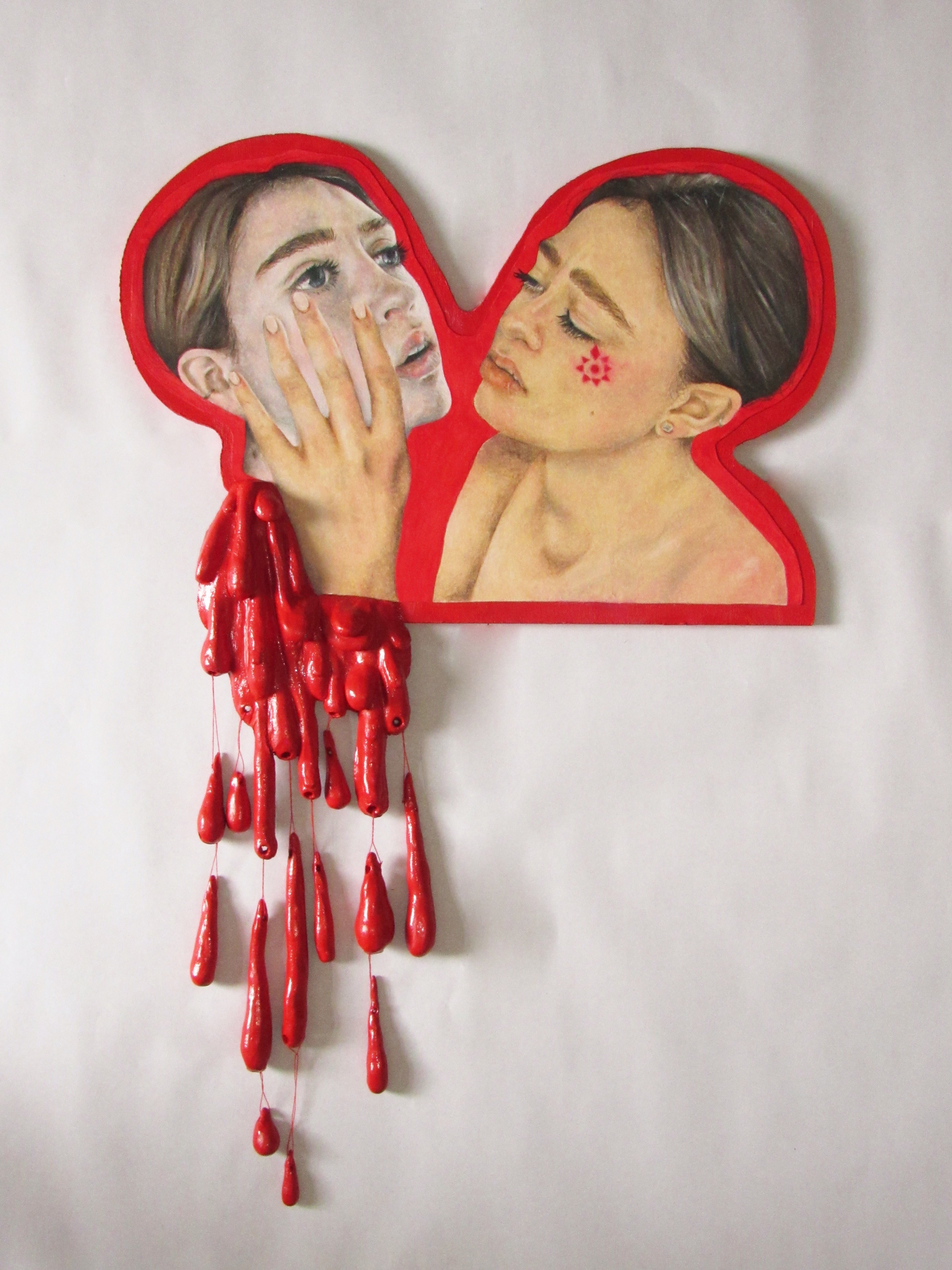 BA Fine Art work by Kate Chaplin showing a mirror image of a woman holding her own decapitated head. Below is a sculptural spilling of blood.