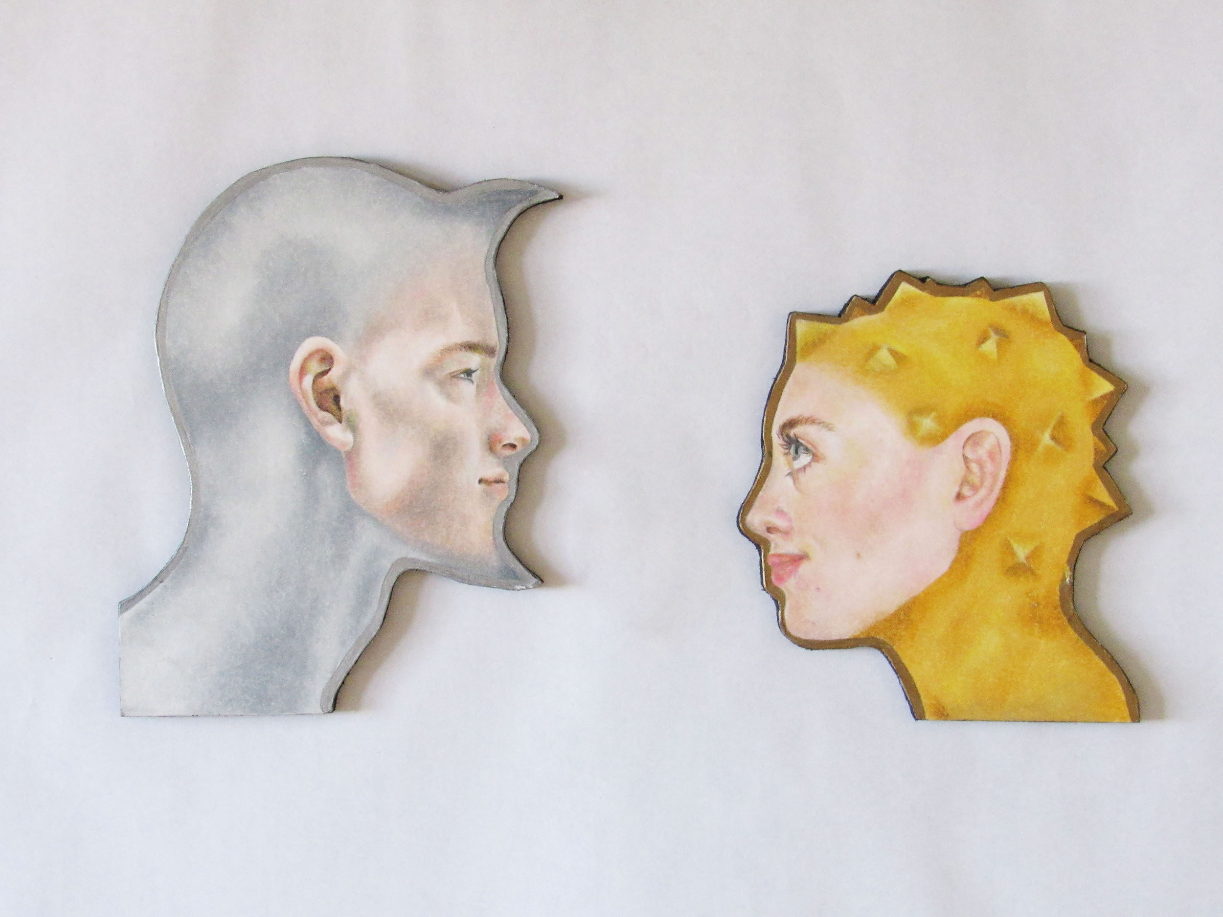 BA Fine Art work by Kate Chaplin showing a man with a face shaped like the moon and a woman with the head shape of the sun.