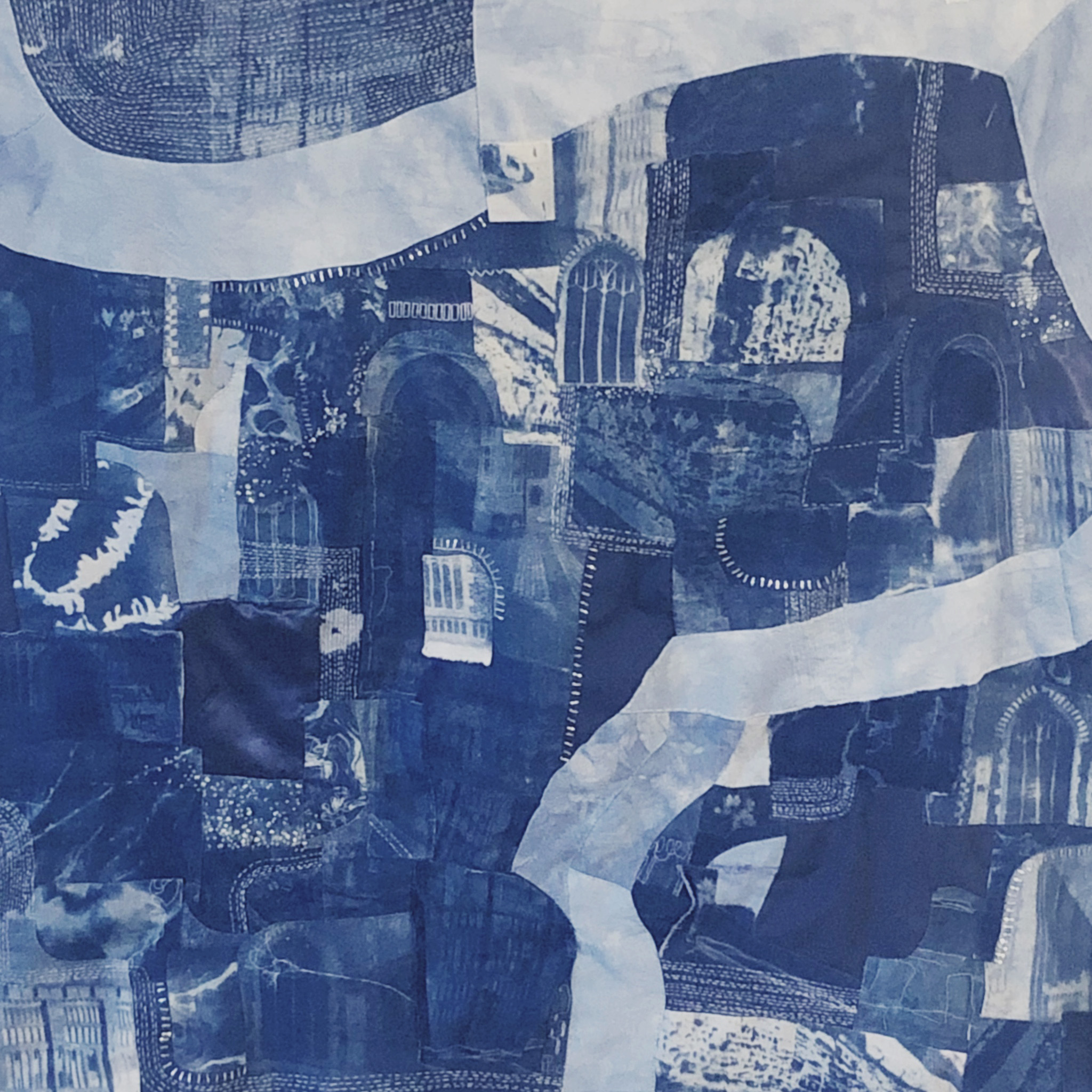 BA Illustration wall hanging made from different shades of blue fabric pieces produced through cyanotype, hand stitched together to create a map composition of Norwich city highlighting some of the Haunted hotspots.