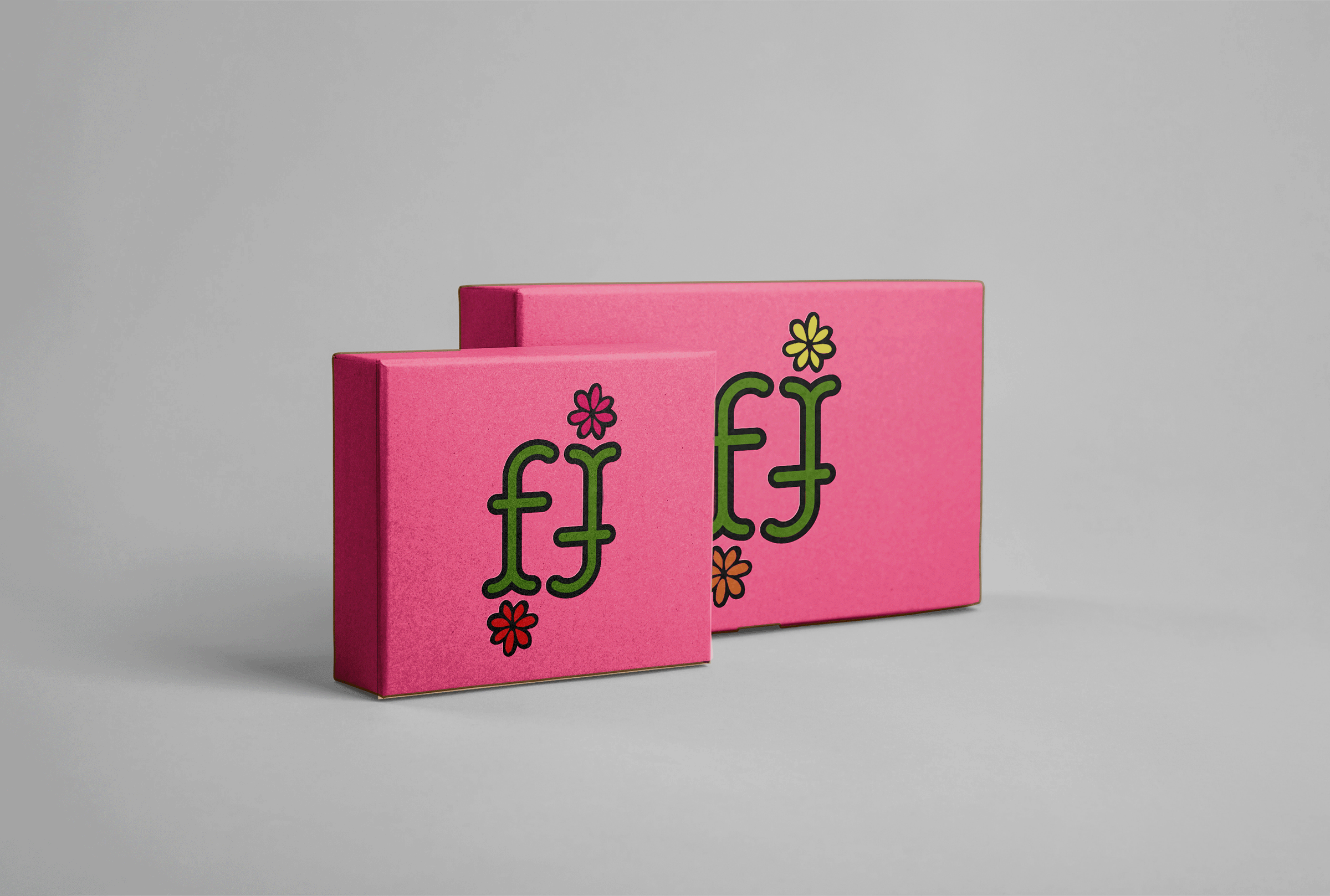 Mock up of two pink rectangular boxes with simple double 'f' design, coloured green, with a small flower at the bottom of each 'f'.