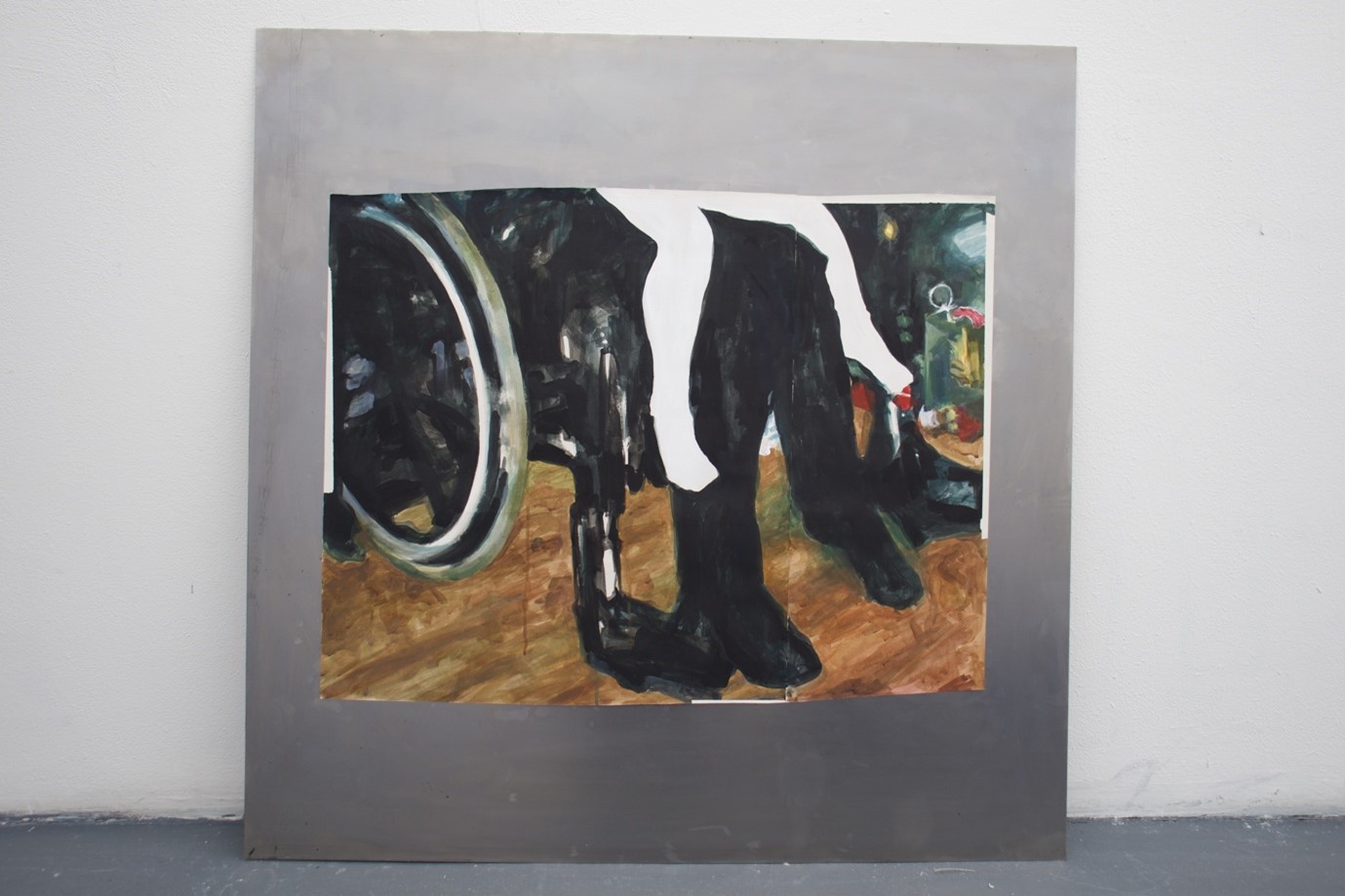BA Fine Art work by Molly Jackson showing a painting of two pairs of legs and a wheelchair on paper, on square steel background.