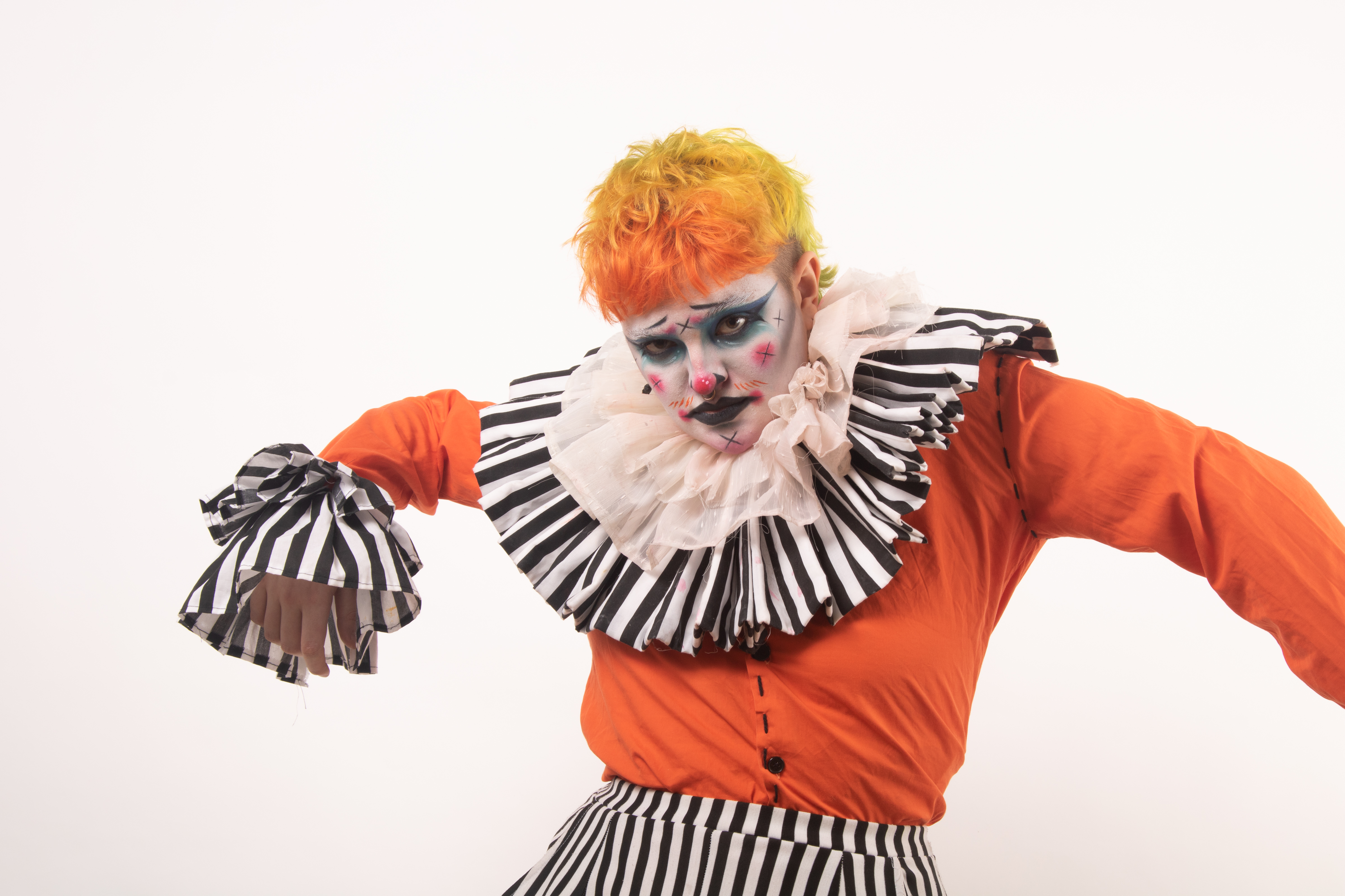 Model in carnival circus themed orange costume