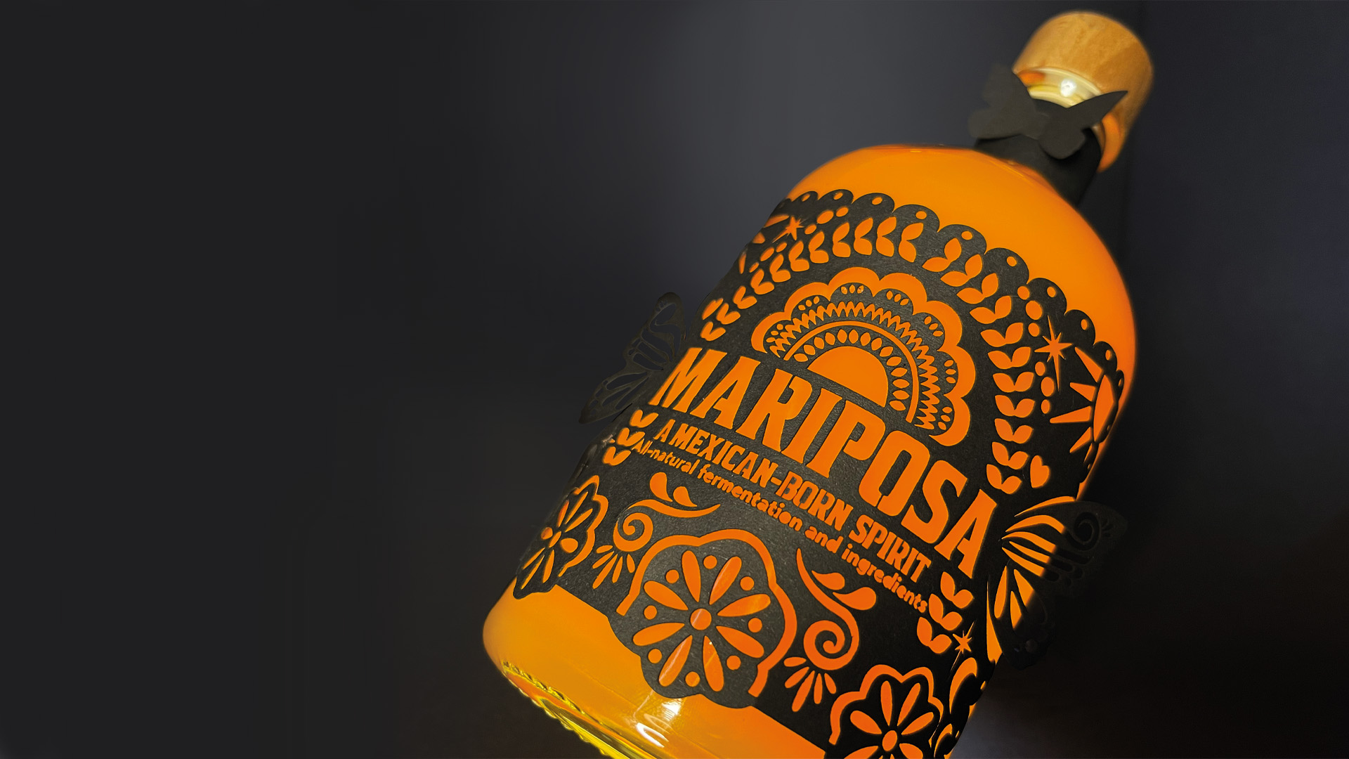 Packaging Design by Abigail Ballard-Lawrence showing orange patterned bottle label design for Mariposa on bottle.