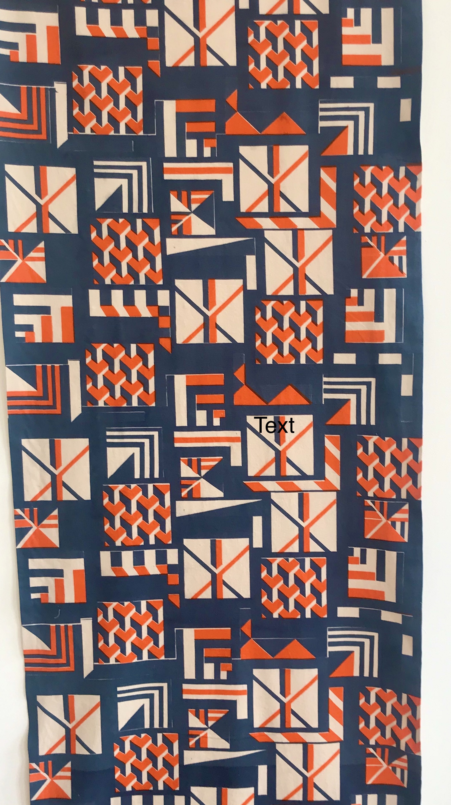 A repeat pattern length that can be used in either an interior or fashion context. Pattern is geometric cream and orange on dark blue.