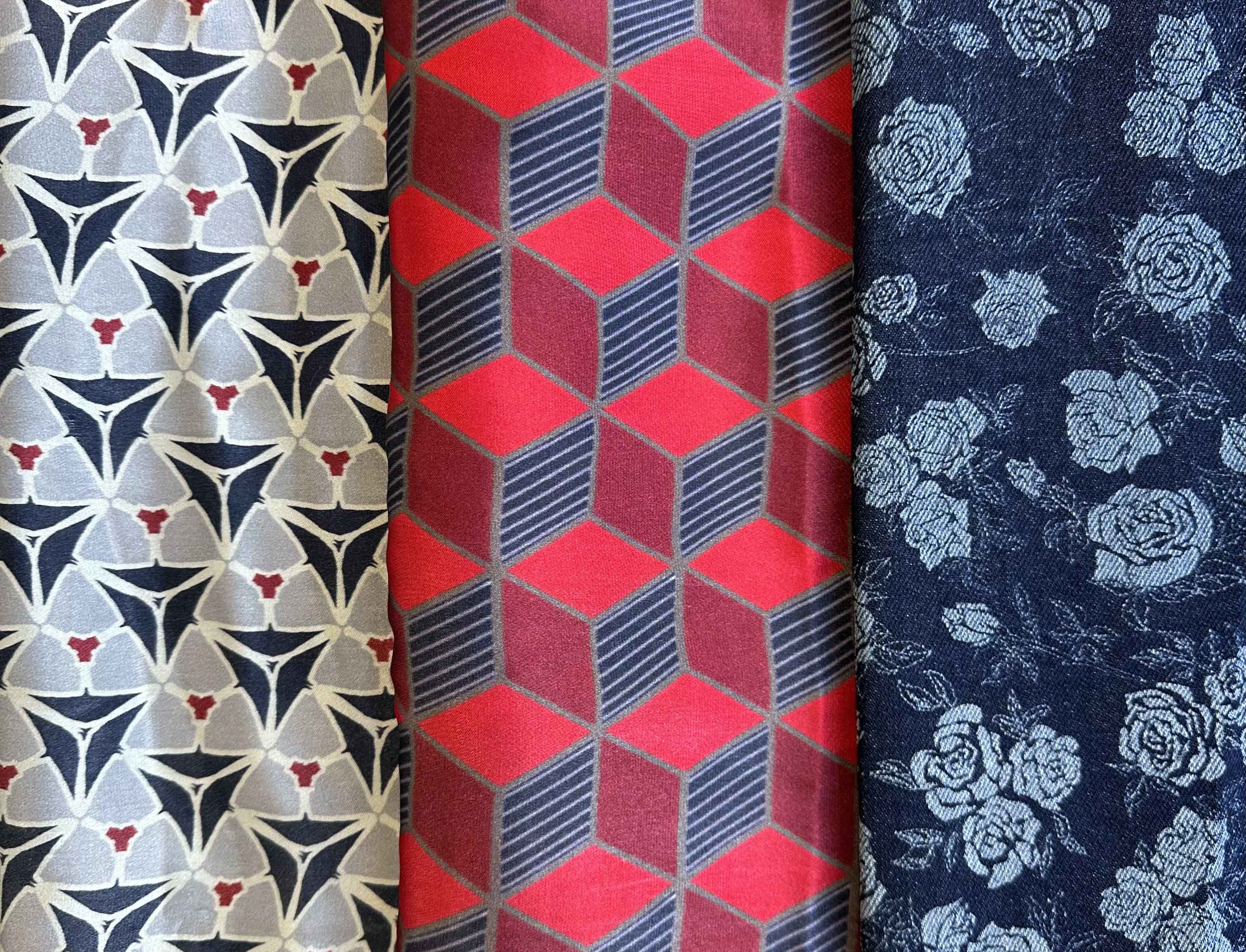 Bold digital prints and denim rastering on denim by Cara Ellaway. Patterns are denim with white and red, one triangular, one geometric cubes and one a rose pattern.