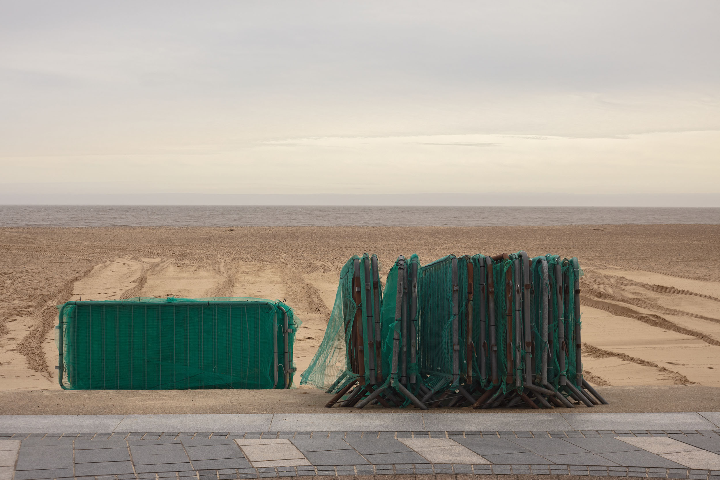 Photograph by Cerys Leahy showing a cluster of temporary fencing set against the beach.