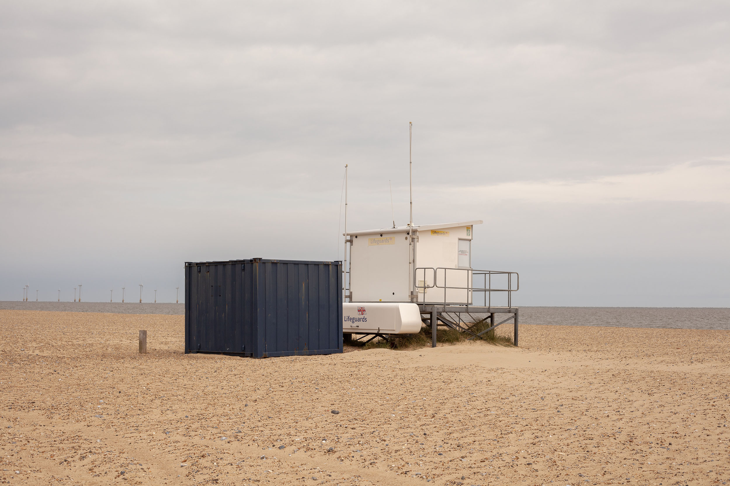 Photograph by Cerys Leahy showing a lifeguard station and container shot central to the beach.