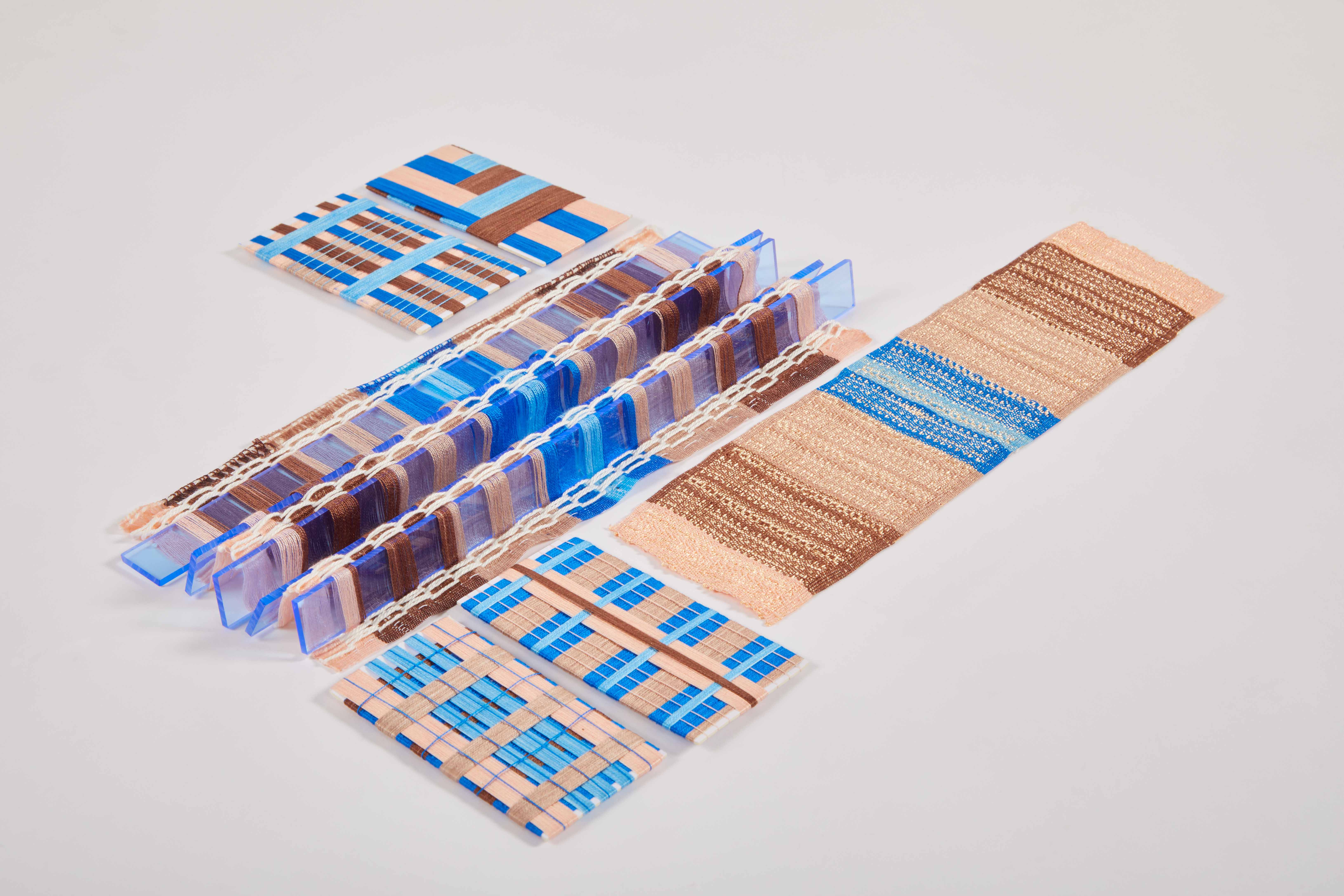 Photograph of woven textiles showing structure of fabric to give sea glass effect. Colours are blue purple and beige neutrals.