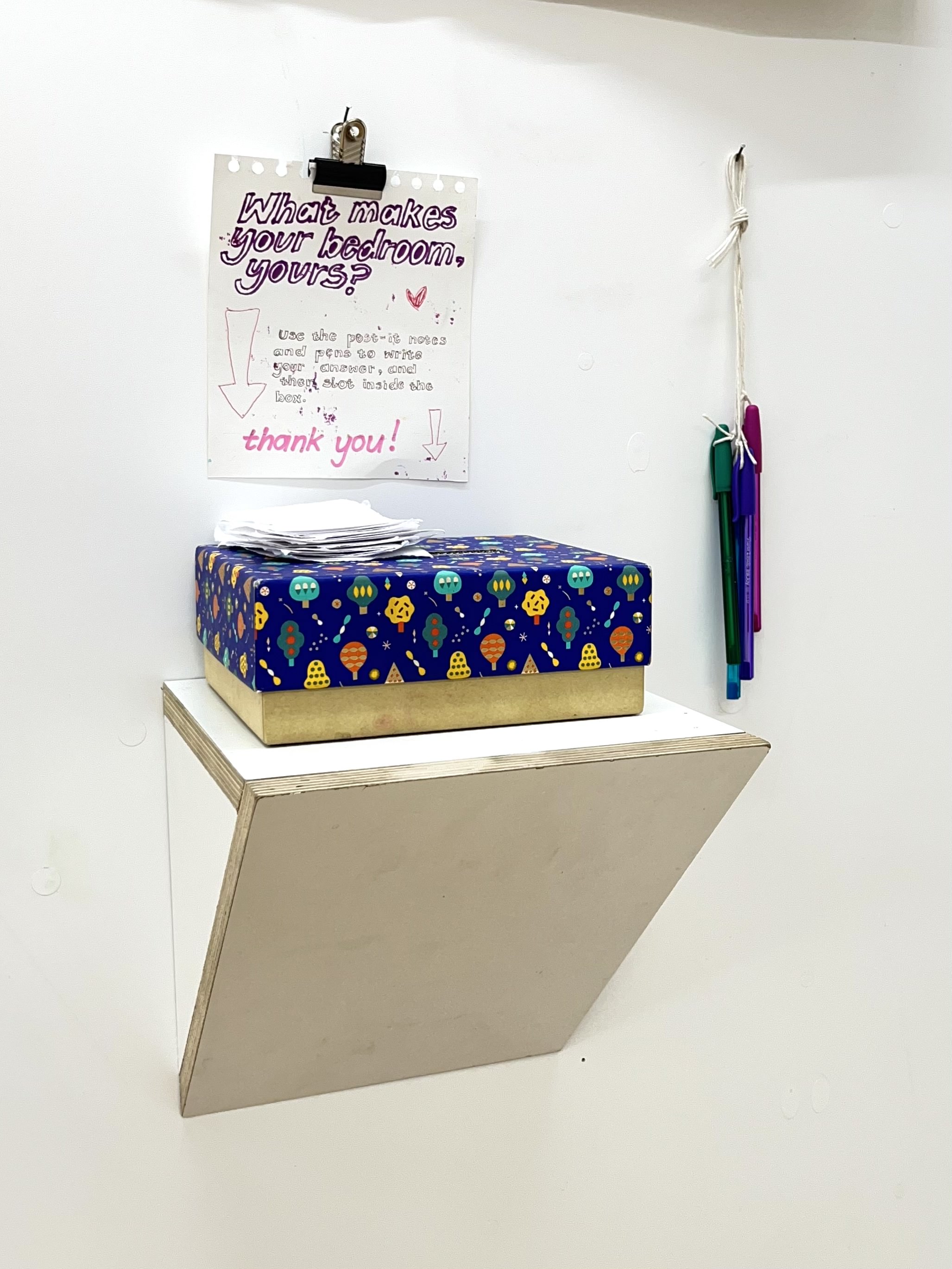 Interactive question box to physically collect the audience's responses. Contains a colourful cardboard box with the question, 'What makes your bedroom, yours?'.