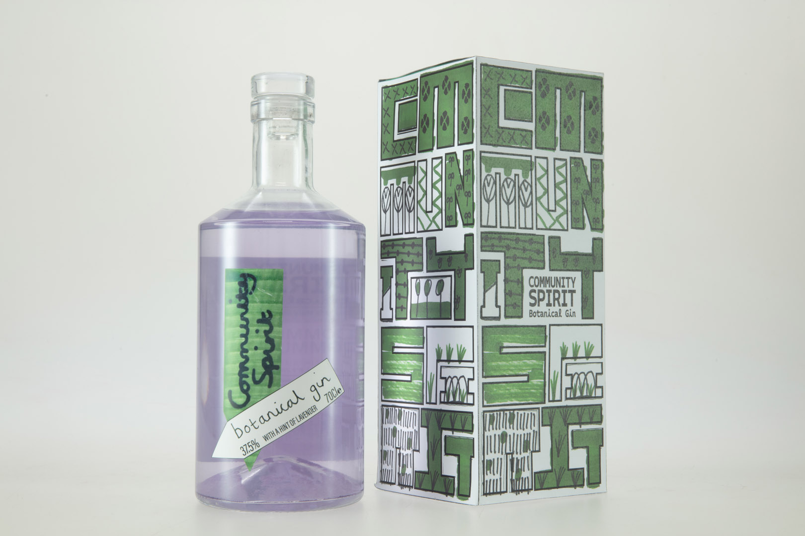 Photograph of Bottle and Box Design for Community Spirit Gin by Dan De'ath. Bottle has green label with purple liquid in, box has green design with large boxy text.