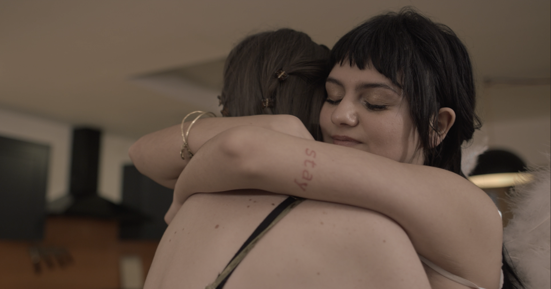 A still of a girl and an angel hugging, from Year 3 Short 'The Fall'