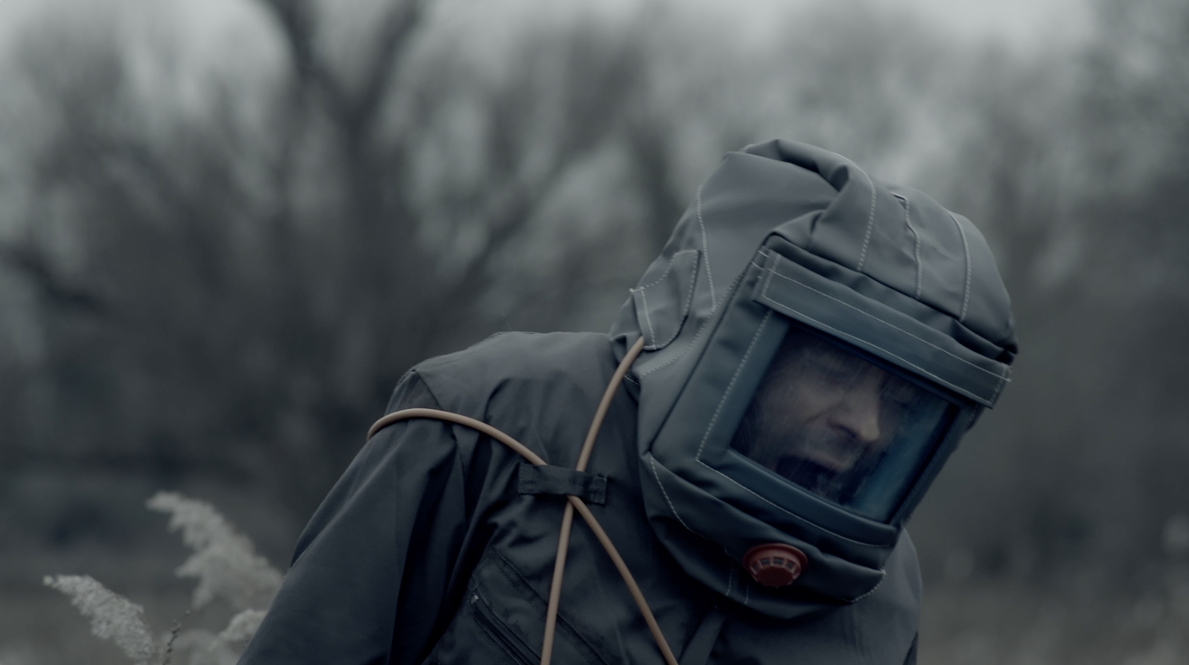 Image link to video clips from 'Alive' by Thomas Briggs, 'The Fall' by Kitty Barnes & 'Our Self' by Lauren Llewella. Image depicts a character in a protective suit