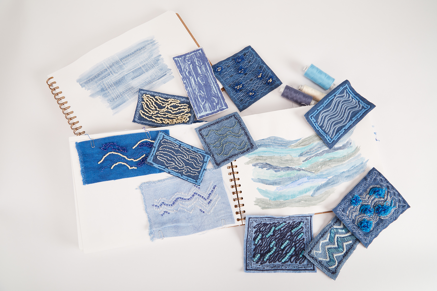 Photo of Initial drawings and hand embroidered patches by Isabel Sanderson
