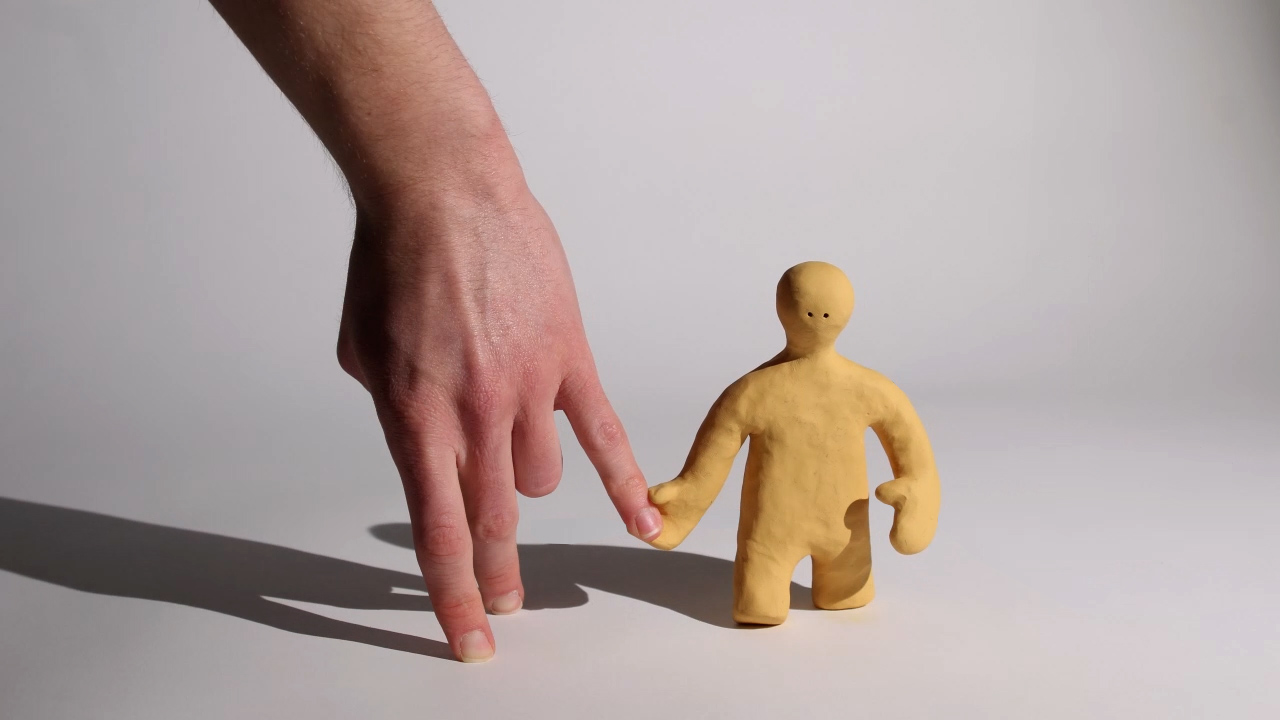 Metamorphosis project for year 2. A stop motion animation with a human hand walking along with a yellow claymation character.