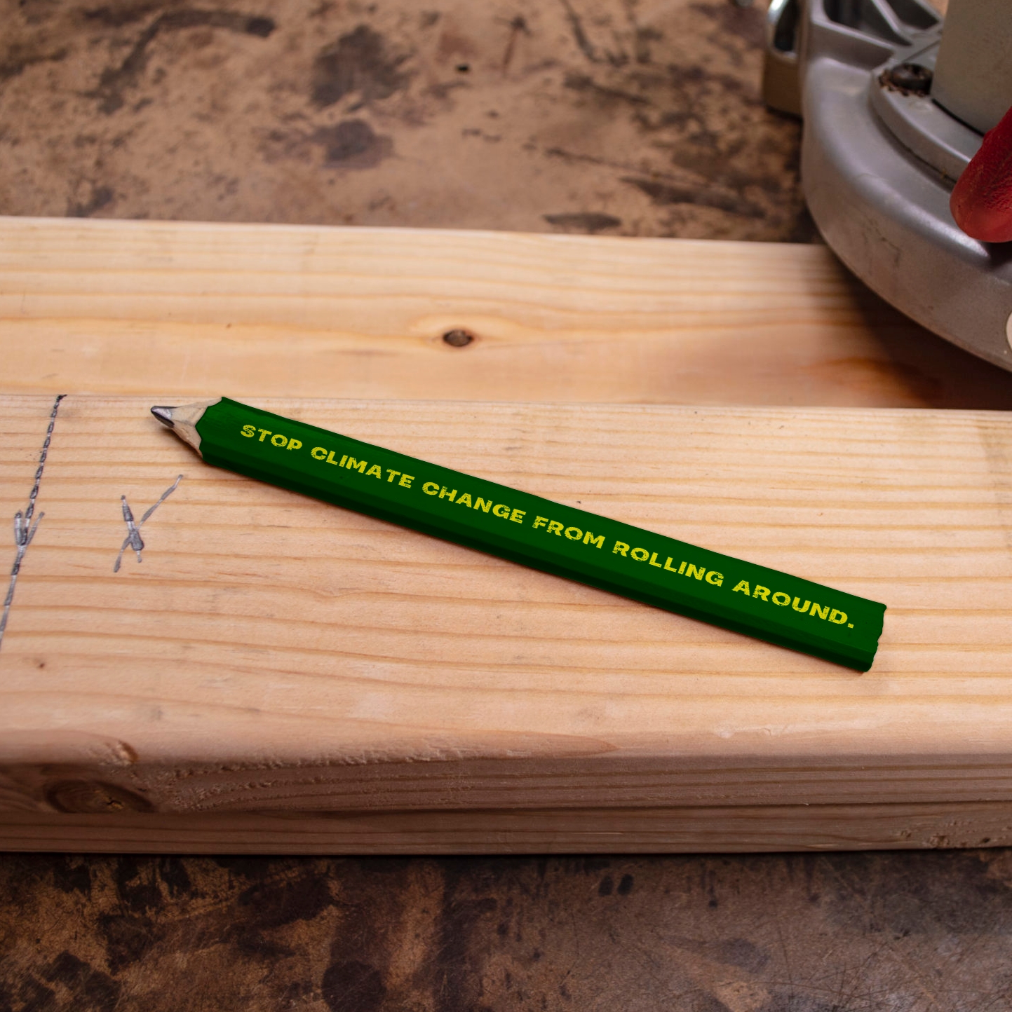 A carpenters pencil being used as a business card for Fair Trade, dark green pencil with yellow text on.