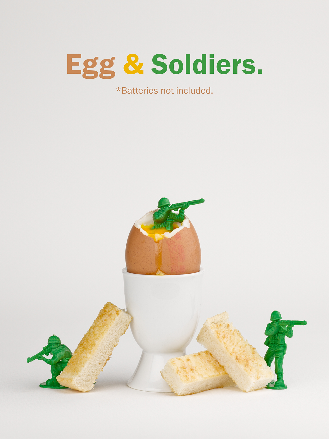A photograph by Joey Rolph, depicting green toy soldiers posted around a dippy egg and toast soldiers.