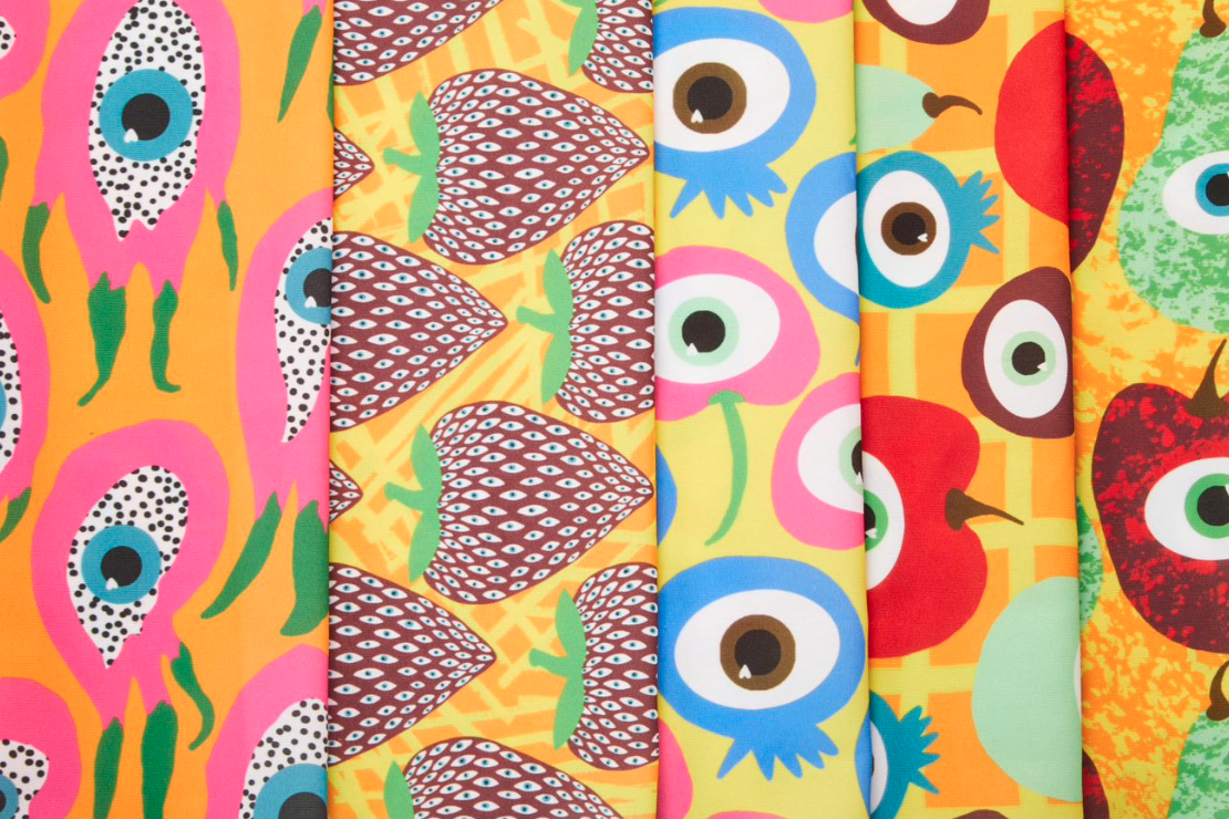 five prints with fruit and eye motifs layered next to eachother.