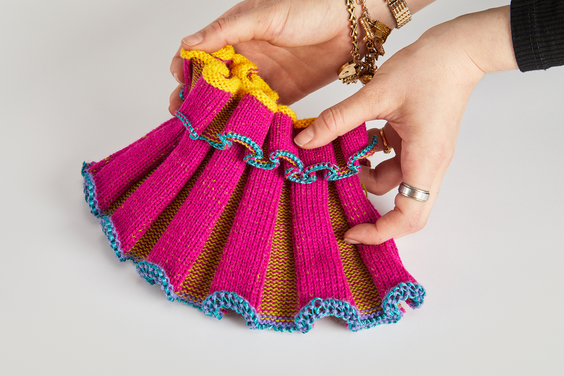 Knitted structural ruff piece; bright pink, green, yellow and blue second hand yarns come together into a maximalist exploration of structural possibilities within knitwear.