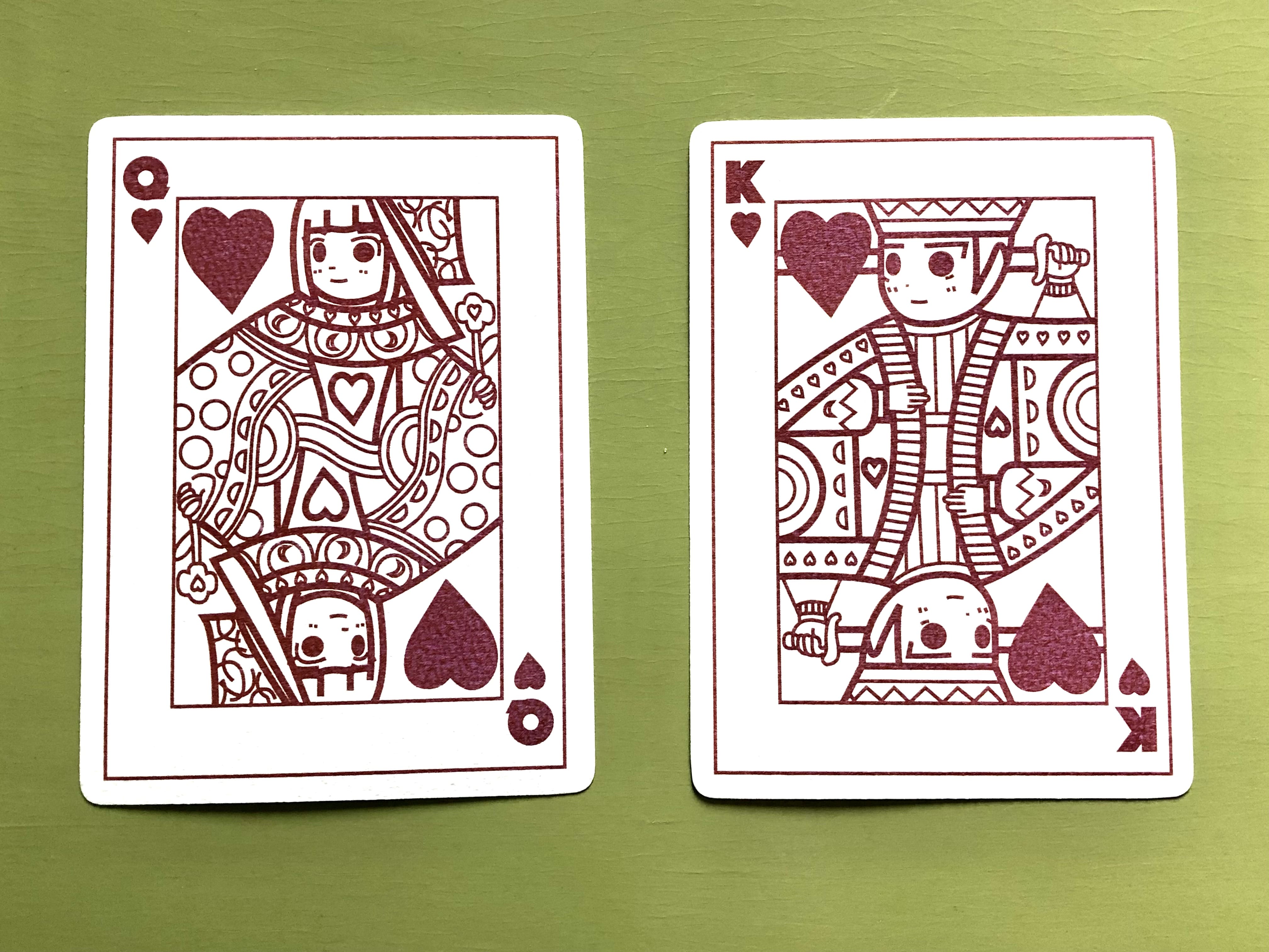 Postcard designs by Pui Ki Tse. Red coloured designs on white card. Design reminiscent of playing cards.