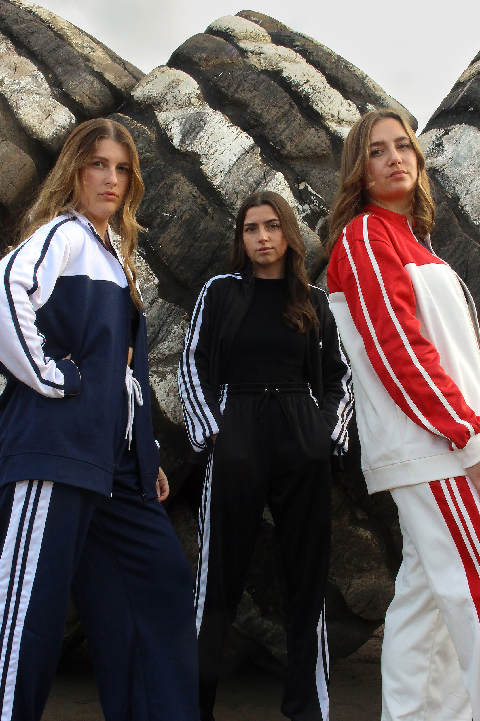 Photograph of three models in tracksuits looking to camera.