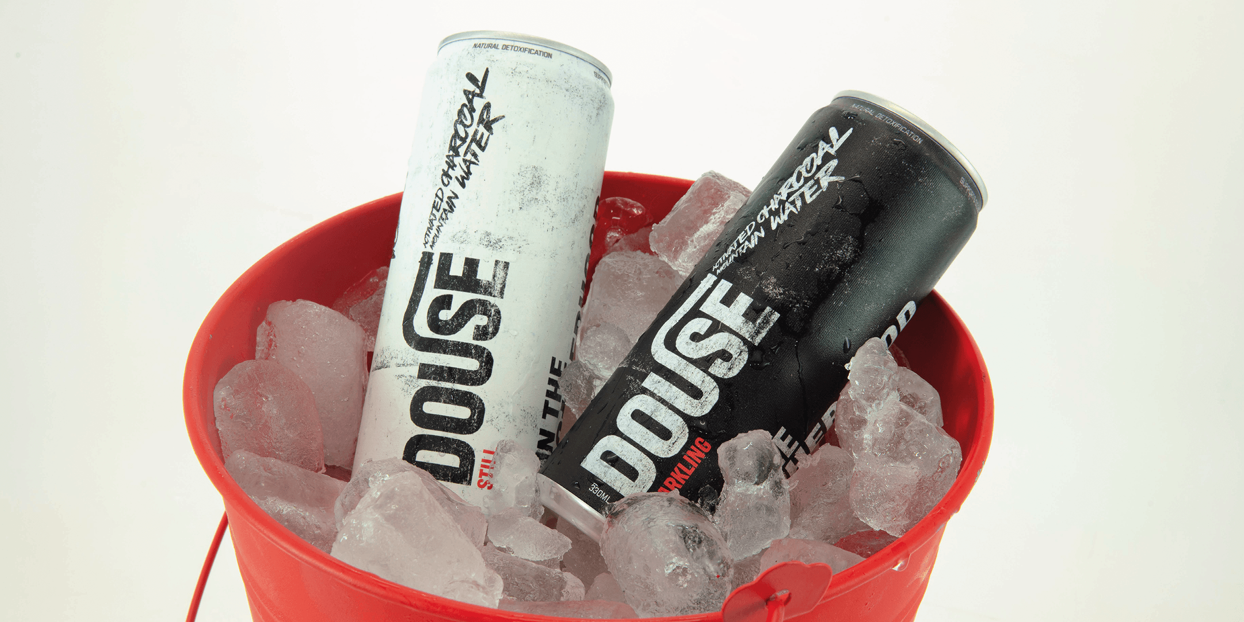 ord douse, with charcoal texted type spraying out to resemble the charcoal water extinguishing the toxins in your body. The logo acts as a tool across the advertising to spread messages about the brand.