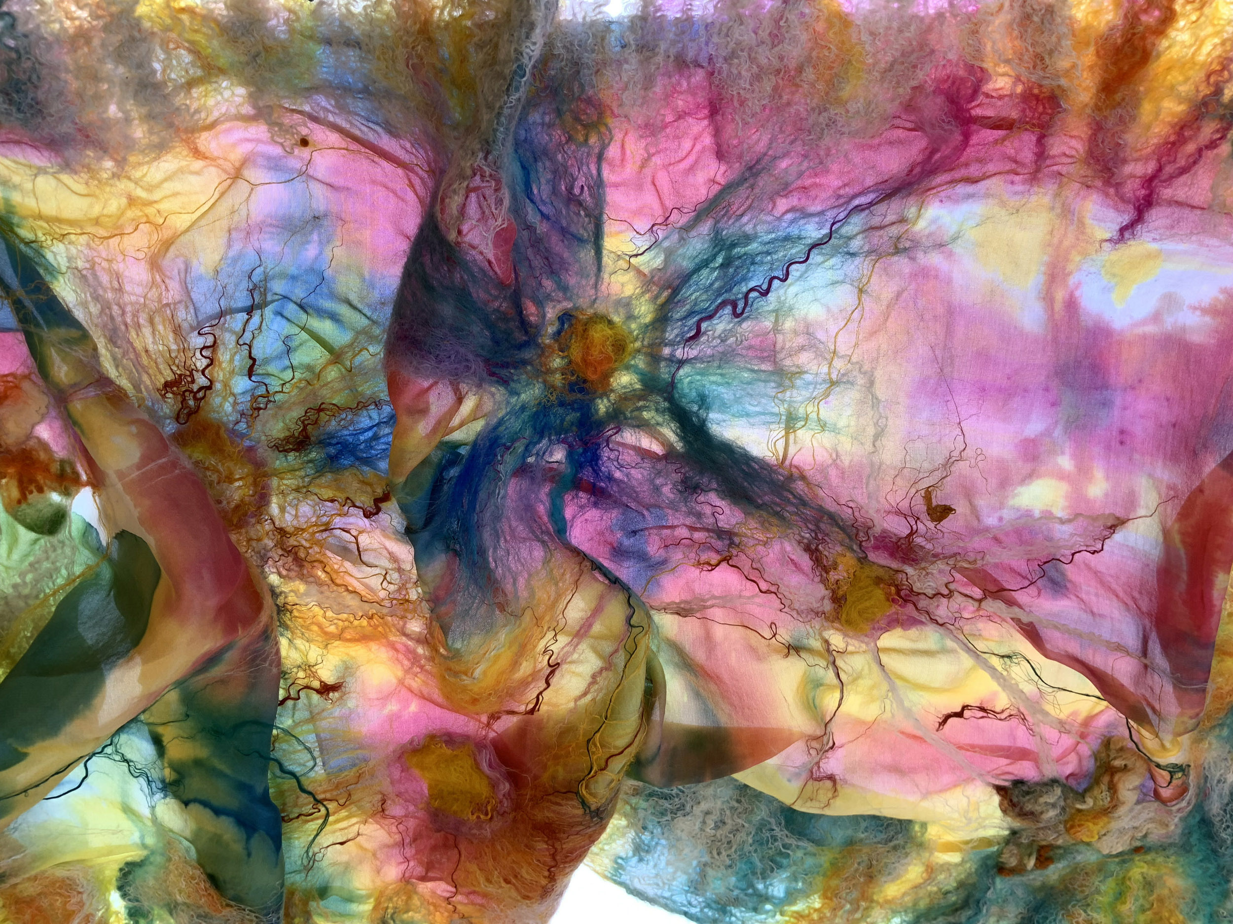 A bright, vibrant hand painted silk scarf.