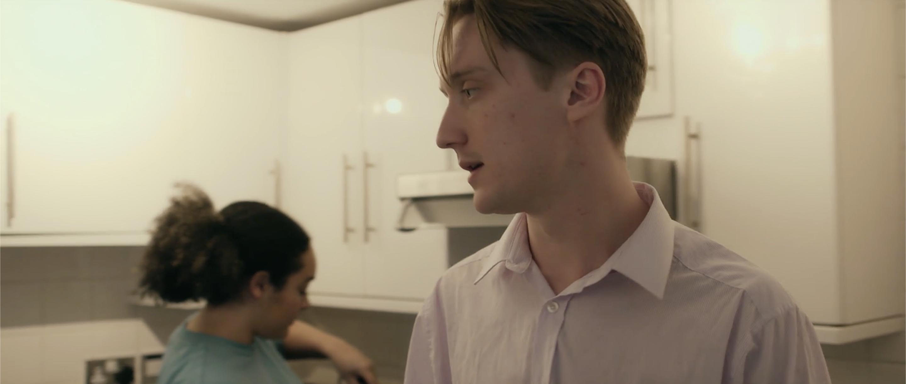 Still from graduate film 'Working Title' shot by South Cuatriz featuring two characters having a conversation in a kitchen