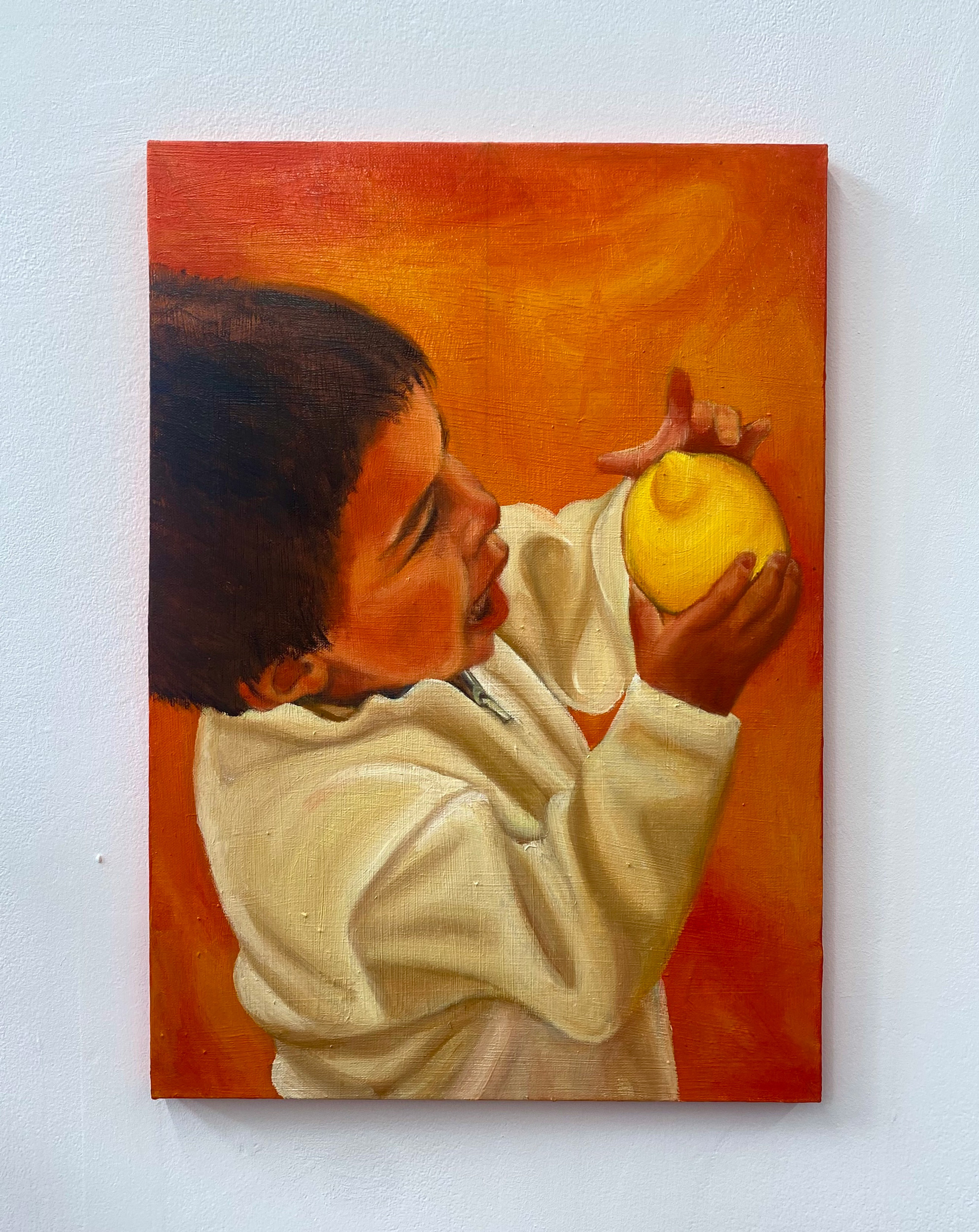 Oil painting on canvas of her brother as a child holding a lemon.